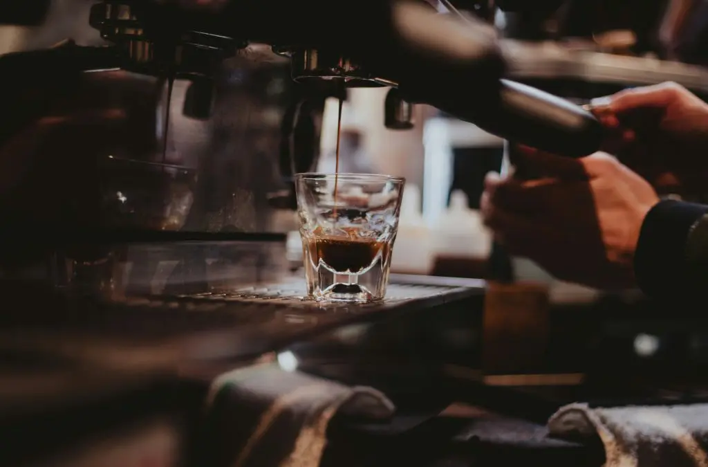 person using manual coffee machine
